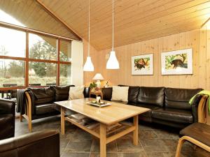 a living room with a couch and a table at 8 person holiday home in Vejers Strand in Vejers Strand