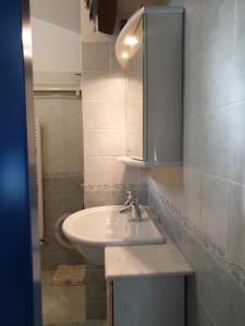 a bathroom with a sink and a mirror at Matteotti 134 in Sanremo +4 photos