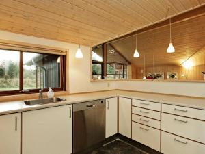 A kitchen or kitchenette at Spacious Holiday Home in Vejers Strand with Sauna