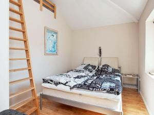 a bedroom with a bed and a ladder at Four-Bedroom Holiday home in Sjællands Odde 2 in Yderby