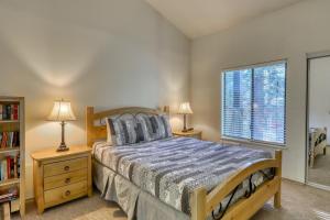 a bedroom with a bed and a window and two lamps at The Summit 276 in Mammoth Lakes +48 photos