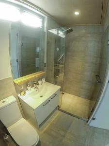 uma casa de banho com um lavatório branco e um chuveiro em Aore Breeze em Luganville
