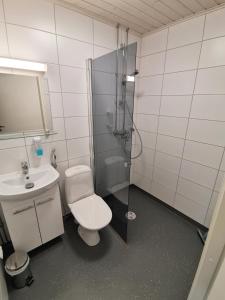 a bathroom with a shower and a toilet and a sink at Forenom Aparthotel Raahe in Raahe
