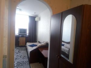 a room with a bedroom with a bed and a mirror at Отель in Malyn