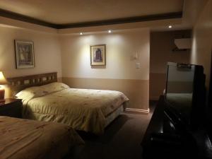 Postel nebo postele na pokoji v ubytování Traveller's Inn