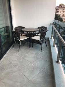 een patio met een tafel en stoelen op een balkon bij Elite Marine Residence in Alanya