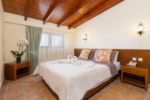 a bedroom with a bed with towels on it at Villas Duc - Rhodes in Ialysos +68 photos