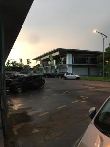 a parking lot with cars parked in front of a building at Home Suhaila in Kota Kinabalu