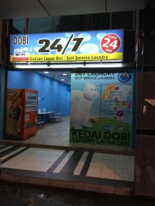 a sign for a koreanorean dog sushi service laundry at Home Suhaila in Kota Kinabalu
