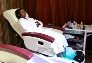 a woman sitting in a chair in a hospital room at Maaha Beach Resort in Anochi