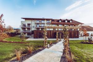 a large building with a pathway in front of it at Landrefugium Obermüller SPA & Naturresort 4,5 Sterne in Untergriesbach