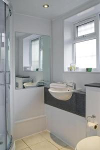 a bathroom with a sink, toilet and tub at Britannia Hotel Wigan in Standish