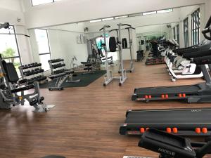 a gym with rows of treadmills and machines at KJ Homestay Casa Kayangan in Ipoh