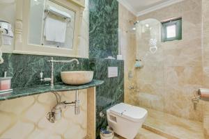 a bathroom with a sink and a toilet at Cunda Esen Hotel in Ayvalık