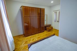 a bedroom with a bed and a large wooden cabinet at At Nana's in Lagodekhi +45 photos