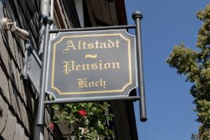 a sign for a restaurant on the side of a building at Altstadt-Pension Koch in Goslar