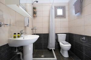 a bathroom with a sink and a toilet at George Poros house in Poros +17 photos
