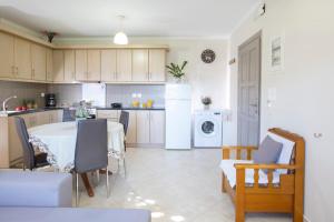 a kitchen and dining room with a table and chairs at George Poros house in Poros
