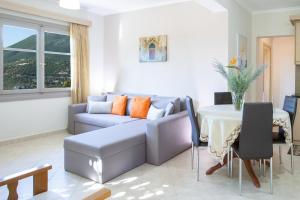 a living room with a couch and a table at George Poros house in Poros