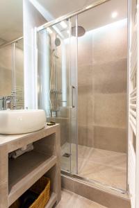 a bathroom with a glass shower and a sink at Dreamyflat - Ste Croix in Paris