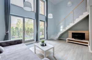 a living room with a couch and a fireplace at 3 City Apartments - Waterlane Valhalla in Gdańsk