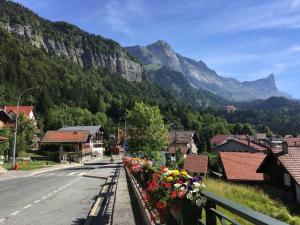 a town with flowers on the side of a road at Fizhome Mt Blanc in Passy