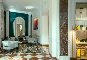 a lobby with chairs and a table in a building at Sofitel Roma Villa Borghese in Rome