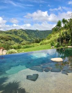 a swimming pool with a view of the mountains at El Sol Monteverde in Monteverde Costa Rica