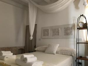 a bedroom with two beds with towels on them at Aria di Casa Country Resort in Alberobello +120 photos