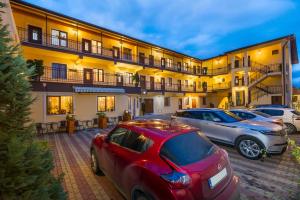 a group of cars parked in front of a building at Long Street Hotel in Braşov