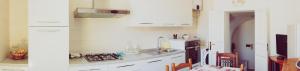 a kitchen with white cabinets and a sink at Casa Cardi in Sperlonga