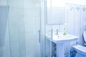 a bathroom with a sink and a glass shower at Casa Cardi in Sperlonga