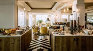 a kitchen with a counter with food on it at Sofitel Golfe d'Ajaccio Thalassa Sea & Spa in Ajaccio