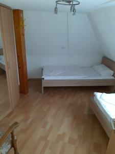 a small room with a bed and a wooden floor at Apartment Öffingen 77 in Fellbach