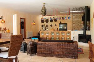 a living room with a table and chairs and a tv at Casa d'Aldeia in Rio Maior