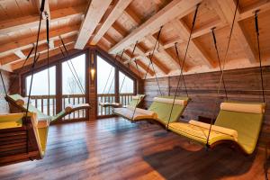 a room with swinging chairs in a log cabin at Wellness- und Vitalhotel Böhmhof in Bodenmais