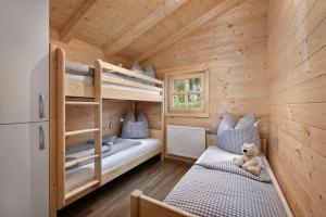 a bedroom with bunk beds in a wooden cabin at Knaus Campingpark Lackenhäuser in Neureichenau