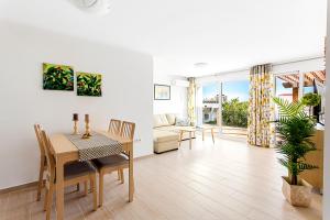 a living room with a table and a dining room at Villa Chispita & Sevilla Torreblanca in Fuengirola