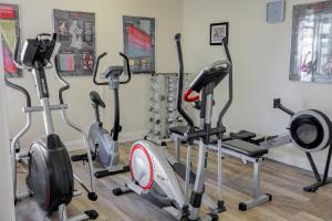 a group of treadmills and exercise bikes in a room at The Monterey Hotel - Sure Hotel Collection by Best Western in Saint Helier Jersey