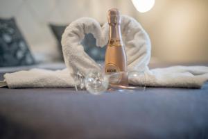 a champagne bottle sitting on a table with a towel at Eolian Port B&B in Milazzo