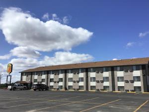 a parking lot in front of a large building at Super 8 by Wyndham Miles City in Miles City