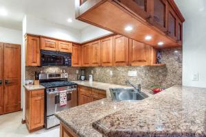 a kitchen with wooden cabinets and a granite counter top at Mountain Village Dream in Telluride