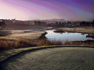 a view of a golf course with a pond at Yarra Valley Lodge in Wonga Park