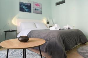 a bedroom with a bed with two stuffed animals on it at CITY CENTER STUDIO 2 in Kalamata