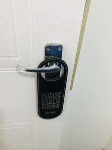 a doorhandle with a sign that reads please do not disturb at Seabreeze Modern Apartment sleeps up to 4 people in Durban