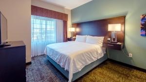 a hotel room with a bed and a window at Staybridge Suites Houston-NASA Clear Lake, an IHG Hotel in Webster
