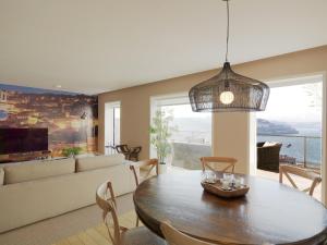 a living room with a table and a couch at FLH - Porto Vista House in Vila Nova de Gaia