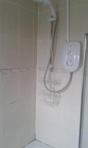a bathroom with a shower with a sink and a toilet at Carvetii - Derwent House - Spacious 2nd floor flat in Grangemouth +7 photos