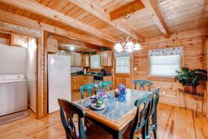 a dining room with a table with chairs and a refrigerator at Country Hideaway in Sevierville
