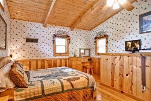 a bedroom with a bed in a room with wooden walls at Sticks And Stones in Sevierville